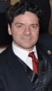 Man in dark suit with red tie